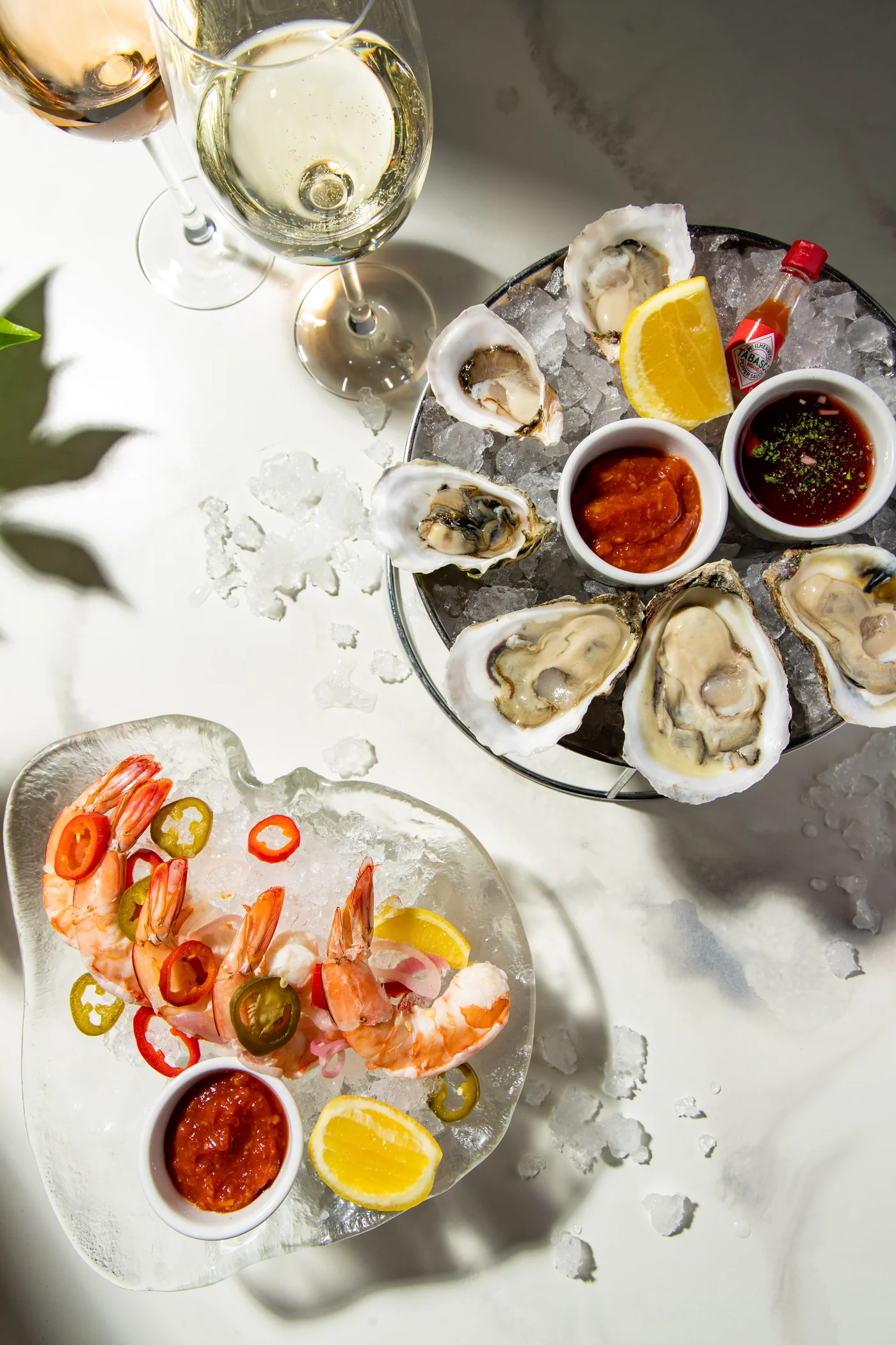 Overhead raw bar at STK Niagara Falls, fresh oysters, shrimp cocktail, and chilled wine