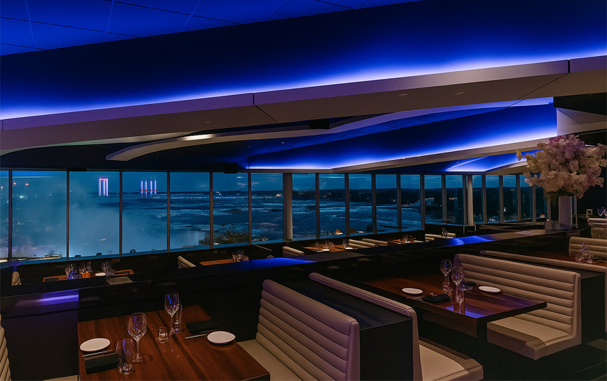The STK Niagara Falls dining room overlooking the illuminated Falls