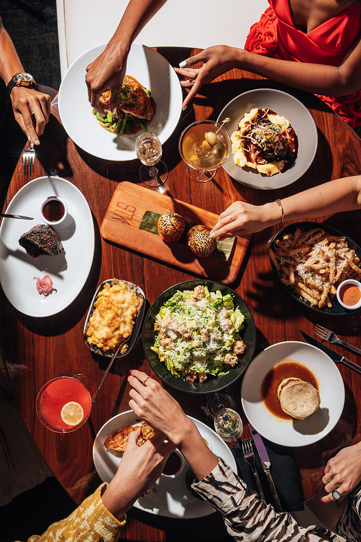 Overhead group dining at STK — shared plates, cocktails